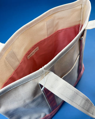 Large heavyweight canvas tote bag with contrast trim, reinforced shoulder straps, exterior slip pocket, and spacious int