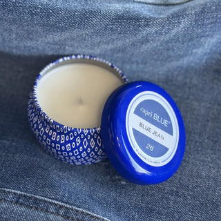 Capri Blue candle with blue lid on denim fabric