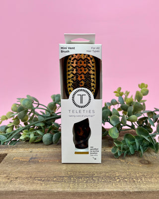 Teleties mini vent brush packaging with leopard print design on a pink background