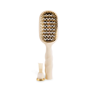 Beige paddle hair brush with gold bristle head on a white background