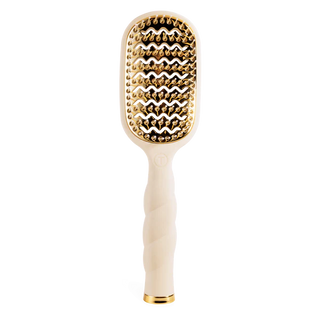 Hairbrush with gold bristle head and white handle on a white background