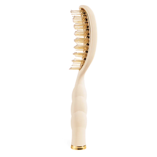 Beige hairbrush with gold bristles on a white background