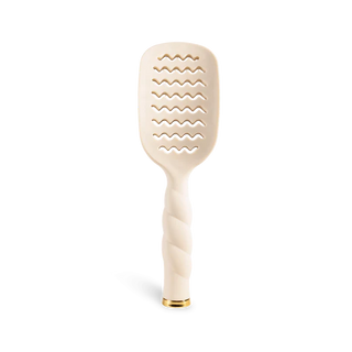 Beige paddle brush with wavy pattern on a white background