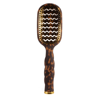 Hairbrush with tortoiseshell handle and gold accents on a white background