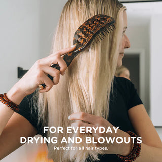 Person brushing long blonde hair with a leopard print brush, text overlay about hair care.