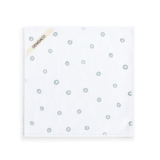White sheet with small gray circles and 'DEMODACO' branding on a white background