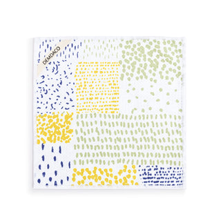 Patterned napkin with blue and yellow dots on a white background